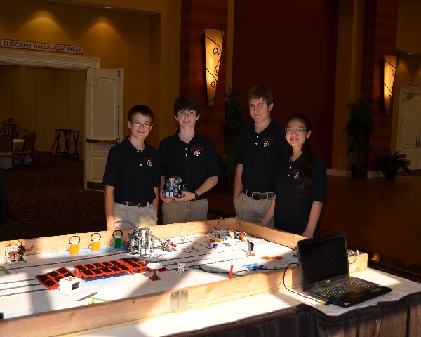 In October, members of the Robo Raiders robots team (l-r) Joe, Scott, Cameron and Justine brief the chapter on their current Lego robot, which they designed and built to compete within the FIRST LEGO League.